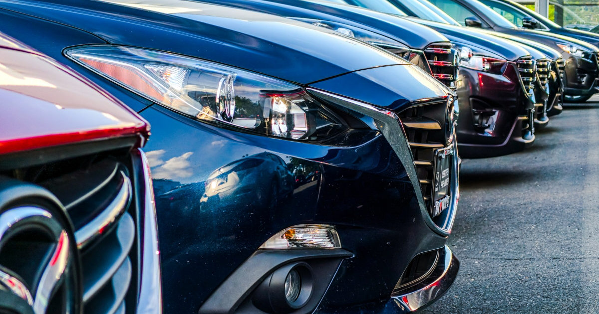 A row of cars lined up in the parking lot