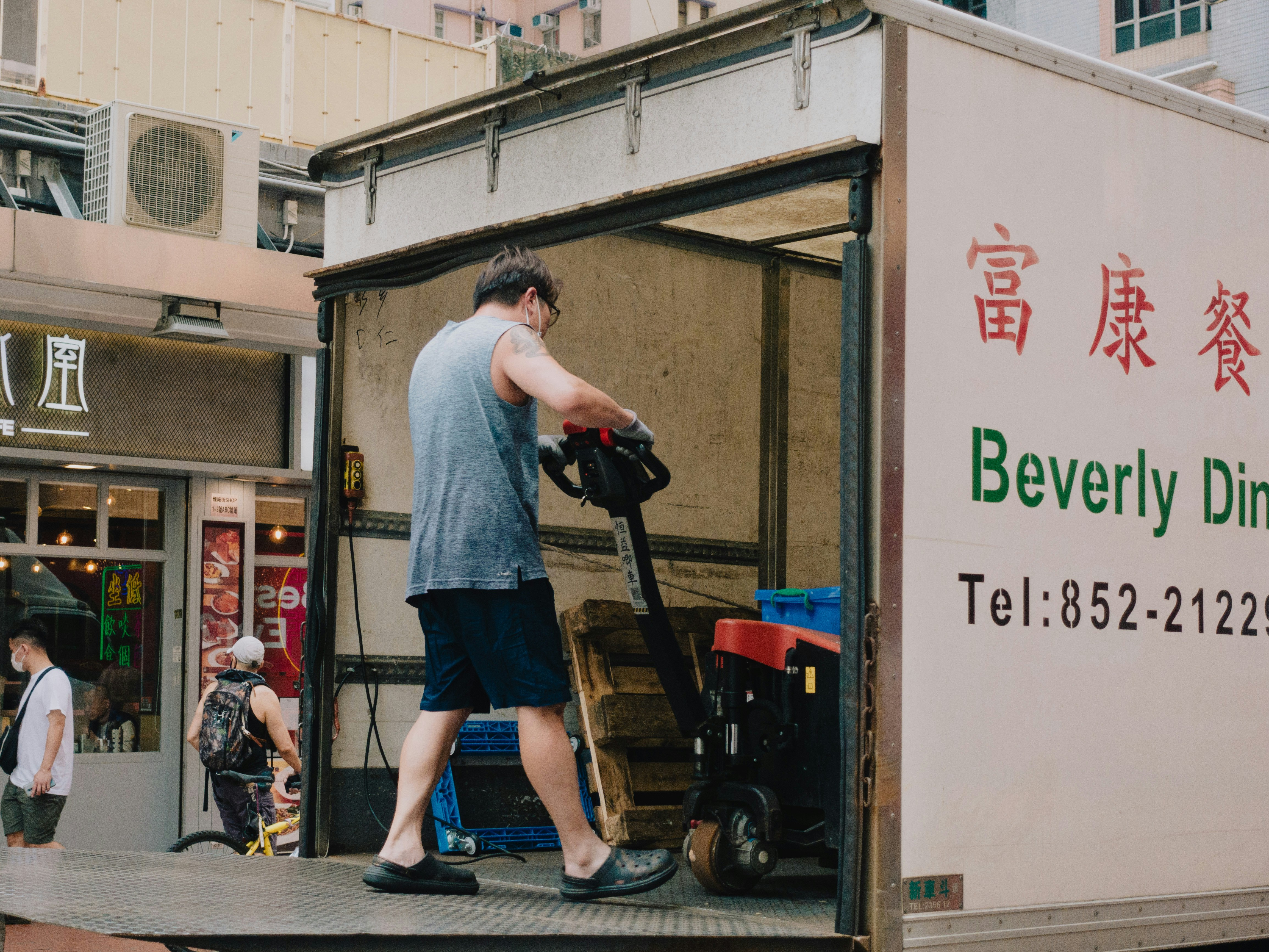 An employee unloads a truck full of merchandise, as depicted by a model.