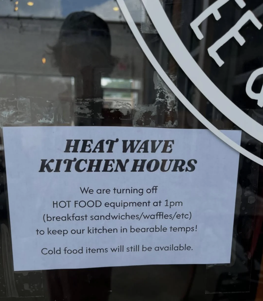 Sign for a restaurant's “heat wave kitchen hours.”