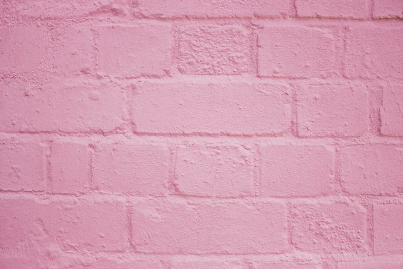 A pink-painted brick wall.