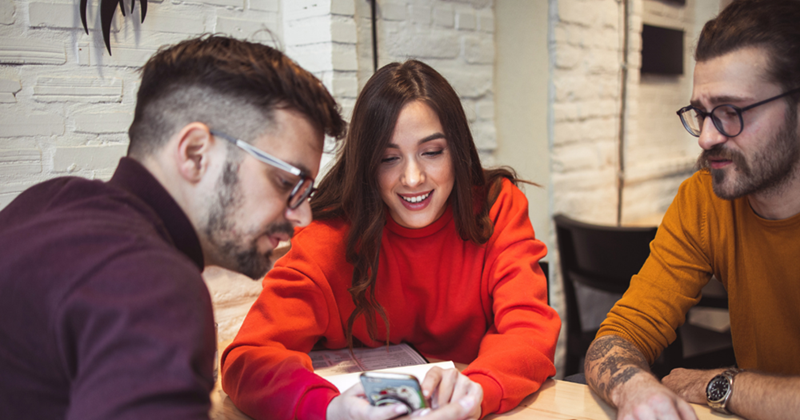 Friends checking the bill at the end of a fun dinner. 