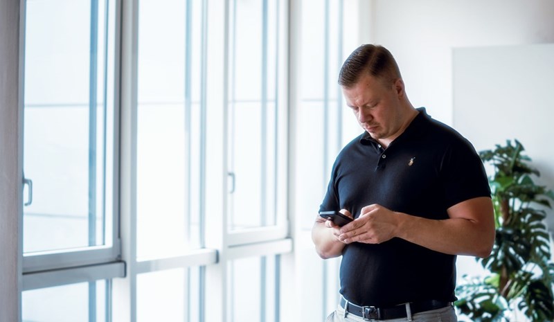 A landlord looks at his phone while inspecting an apartment.
