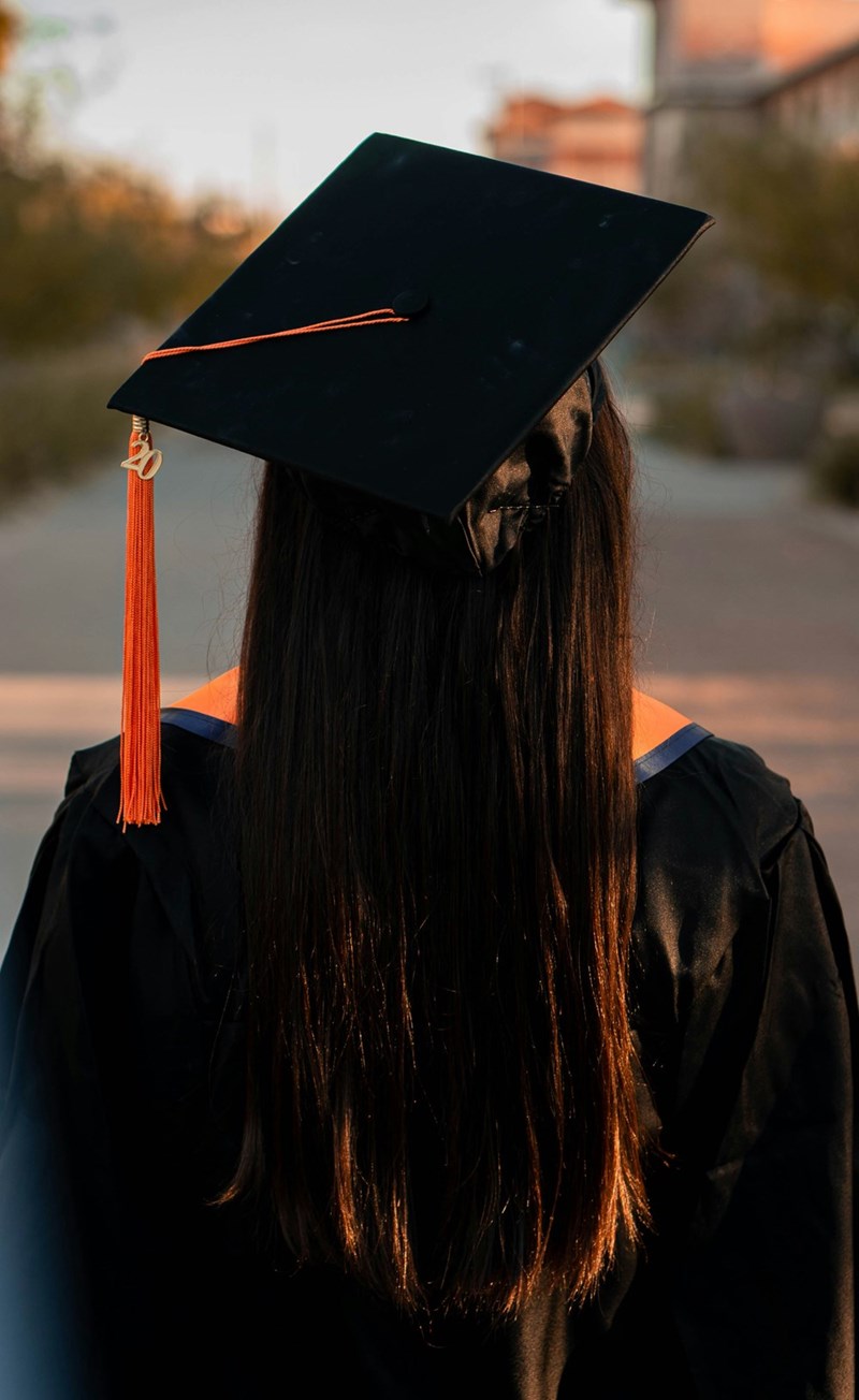 A woman wearing a graduation cap and gown
