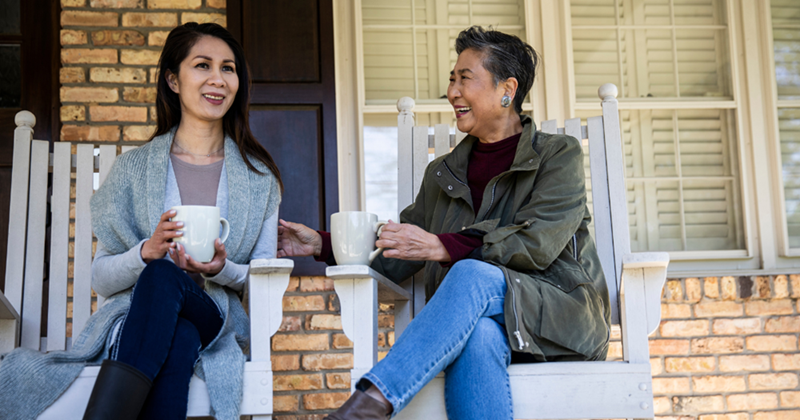A woman is enjoying the afternoon with her senior mother. 