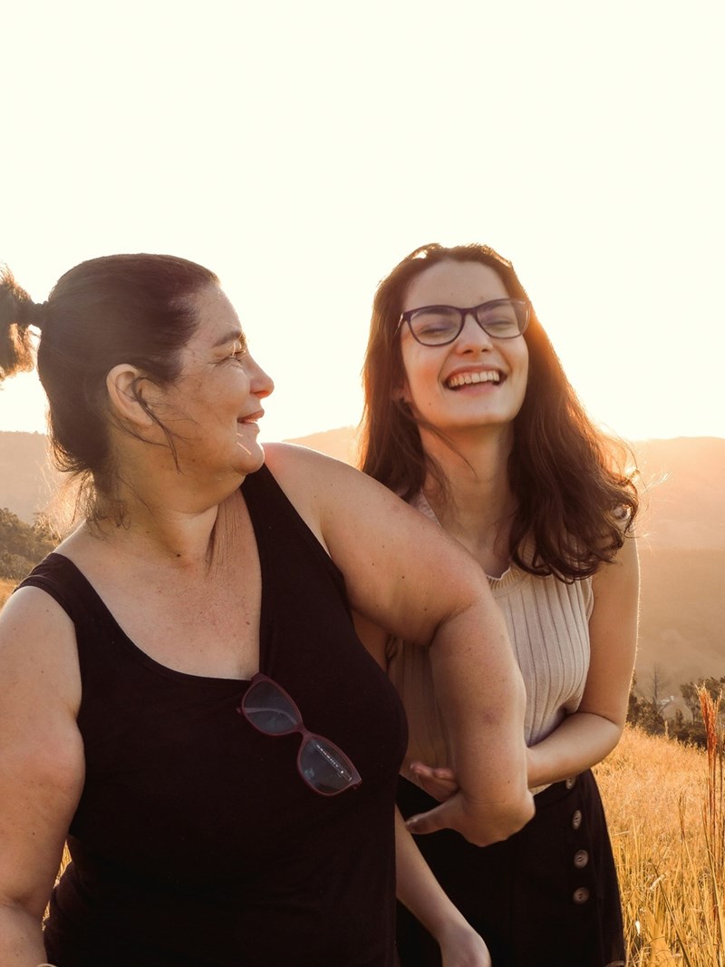 Woman in black tank top beside woman in white tank top