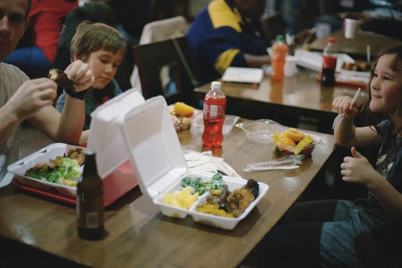 Children eating Chinese food at the lunch table