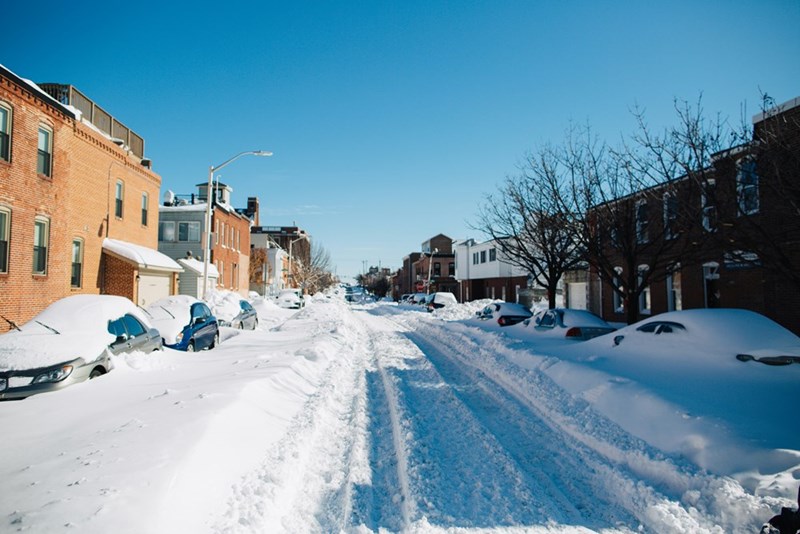 Heavy snowfall on street and cars.