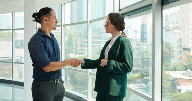 Business Woman Greeting Coworker