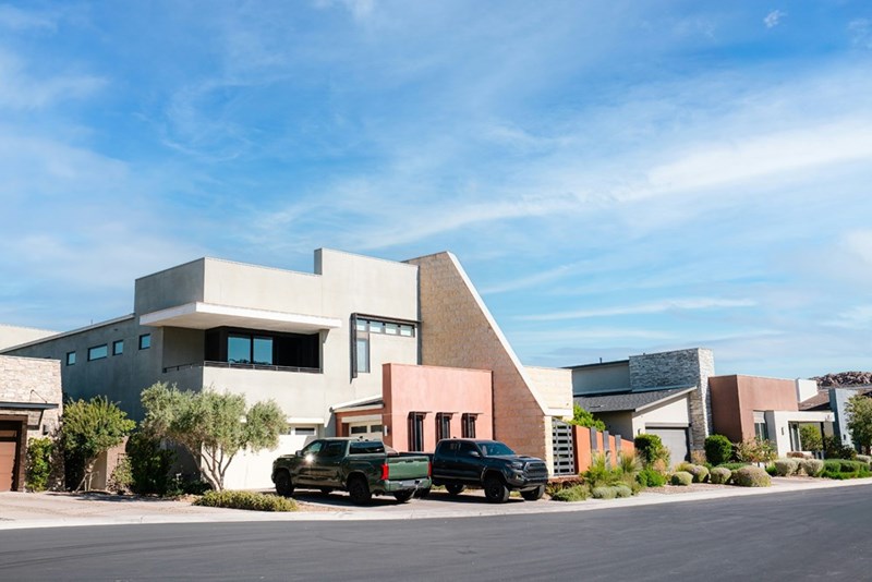 A truck and a car, parked in a driveway.