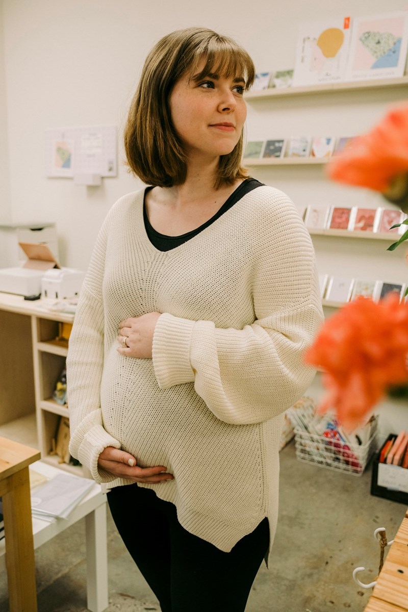 A woman standing in a room with flowers
