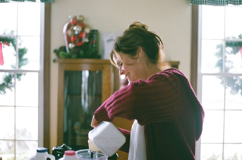 A woman makes breakfast in her home kitchen
