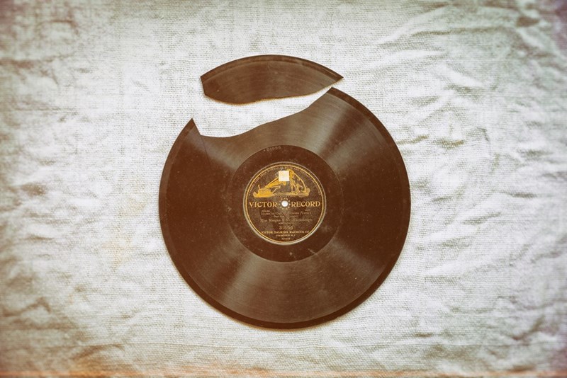 Brown vinyl record on white comforter