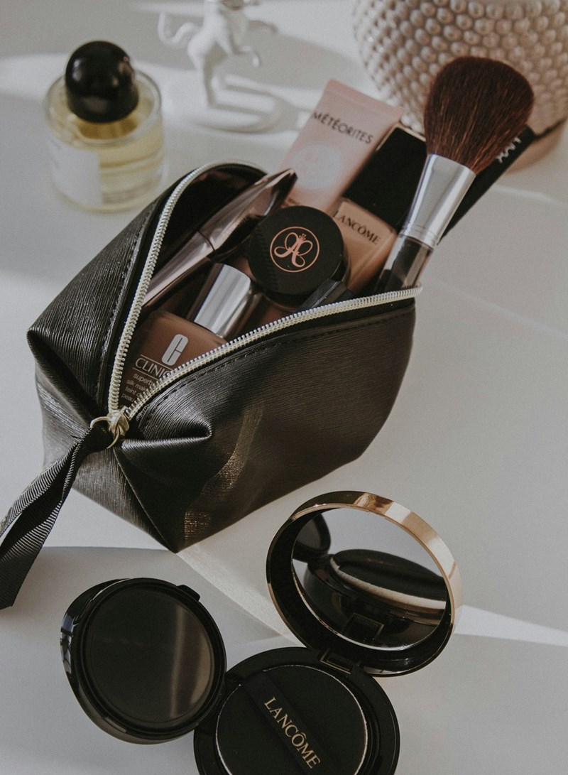 Black leather bag with makeup and makeup brushes