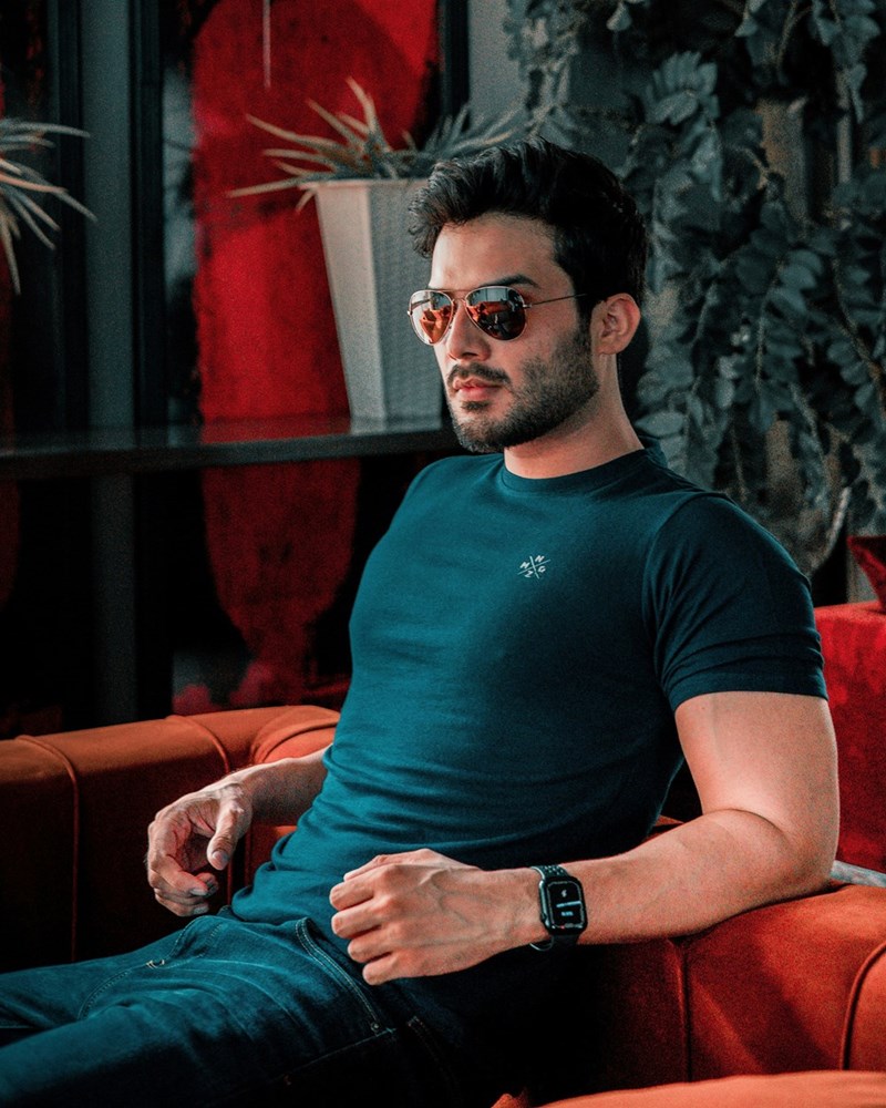 A man in sunglasses sitting on a chair