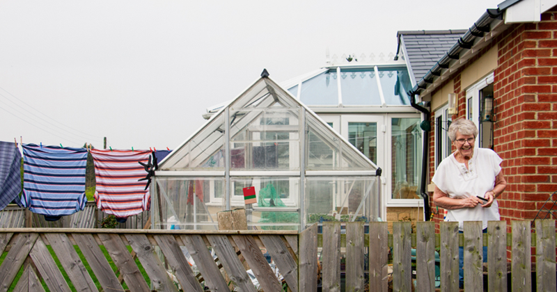 Senior woman enjoying her outdoor space in the garden. 