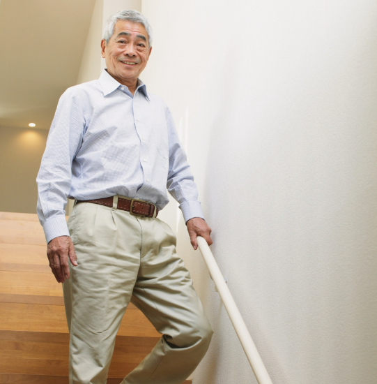 Kind elderly man descending a stairwell.