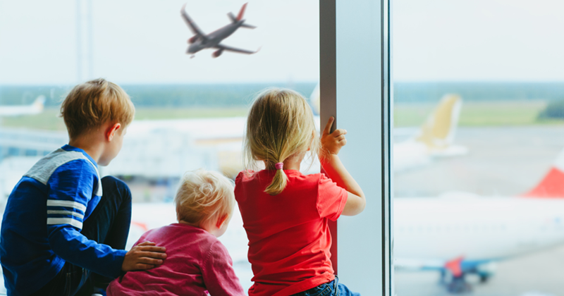 Little kids watching the planes land at the airport. 