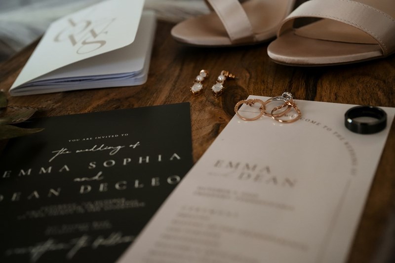 An illegible wedding invitation sits atop a table.