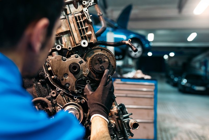 Manufacturing employee assembling precision parts for a client order in a high-tech workshop environment.