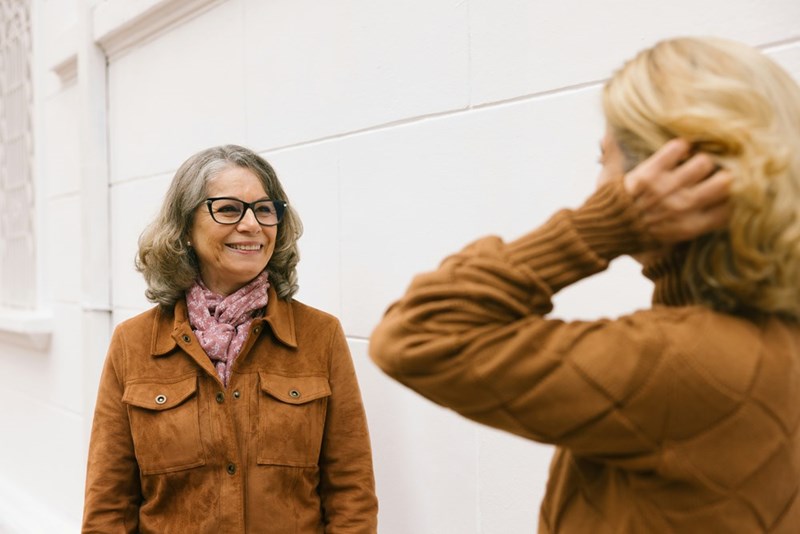 2 neighbors awkwardly greet each other.