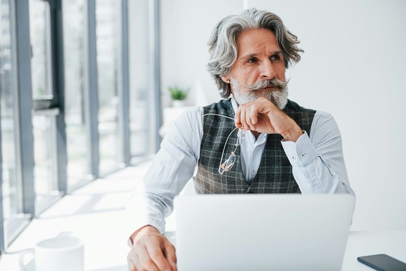 Older man considers what to do after discoving that his HR department wants to fire him.