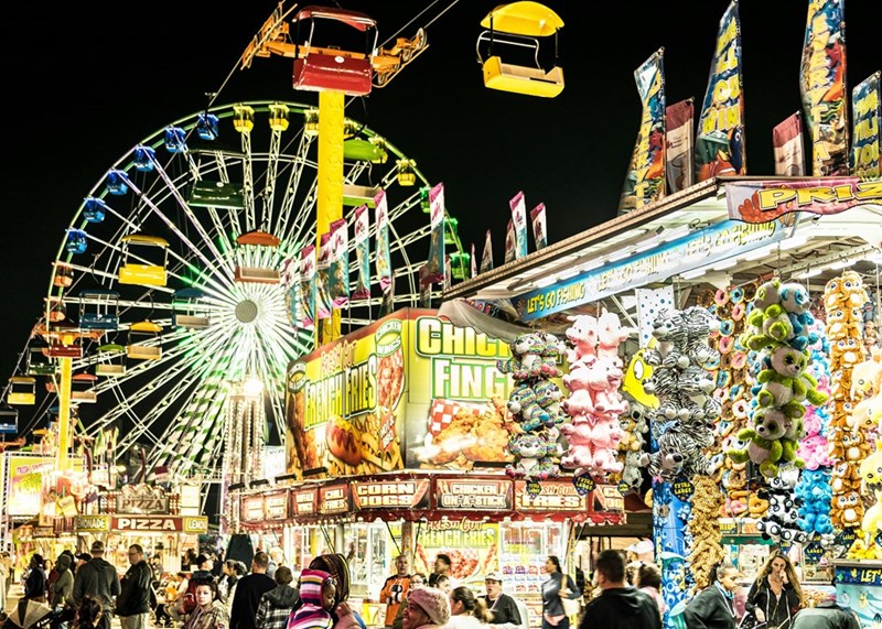 Ferris wheel and carnival games at night