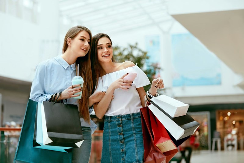 Customers sharing a laugh in a mall.