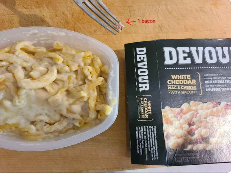 1 bacon DEVOU WHITE CHEDDAR MAC & CHEESE WITH BACON Gemelli pasta in a creamy cheese sauce top WHITE CHEDDAR CHEE and hearty pieces of APPLEWOOD SMOKED DEVOUR WITH BACO MAC & CHEESE CHEDDAR WHITE Mehest quality experience with ou oryour brand is committed to providing the VISIT US ONLINE: devour-foods.com COOK THERE