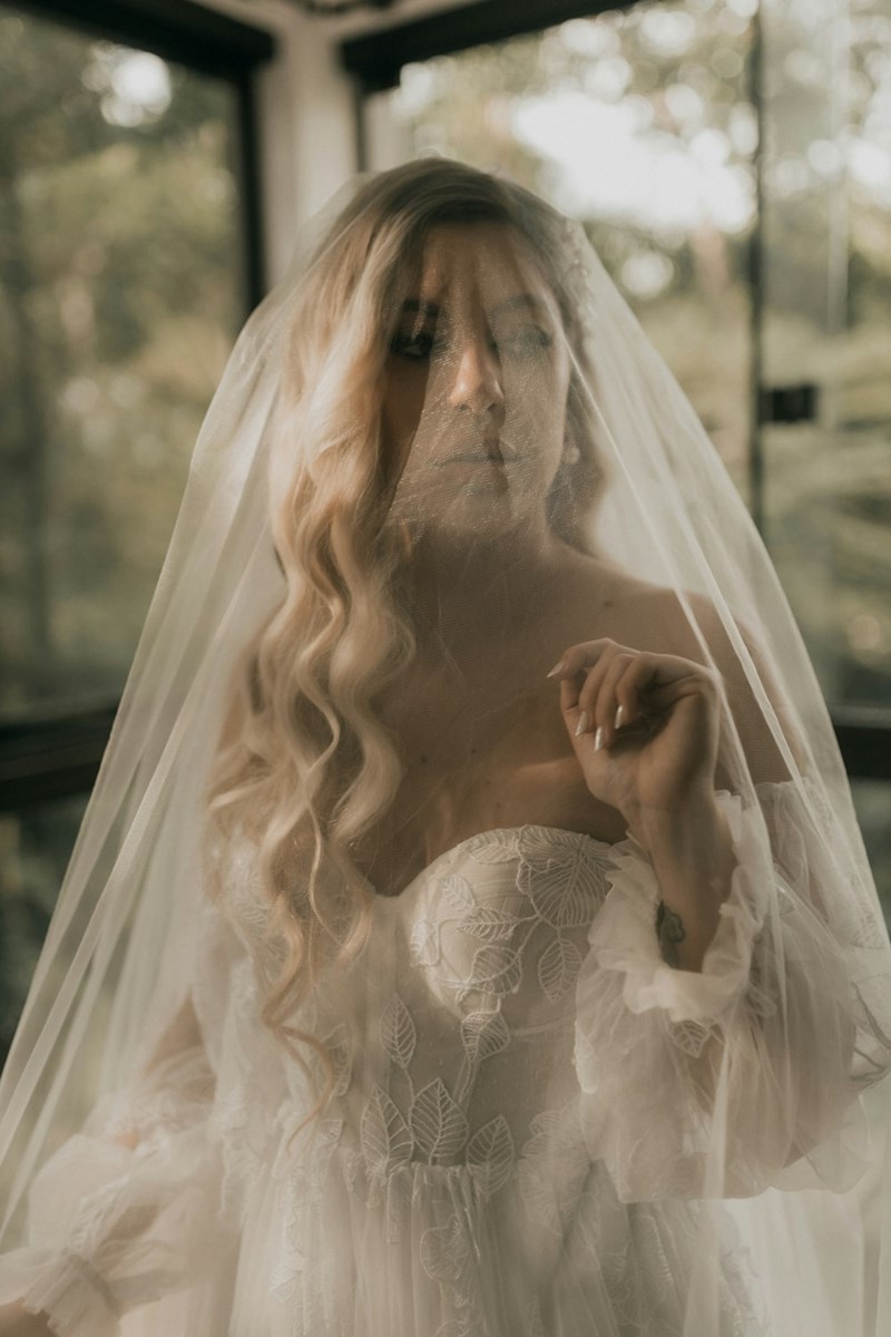 Bride in her dress and veil looking upset at something or someone