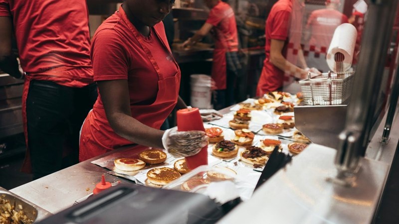 Fast food workers prepare food in a tense fast paced environment