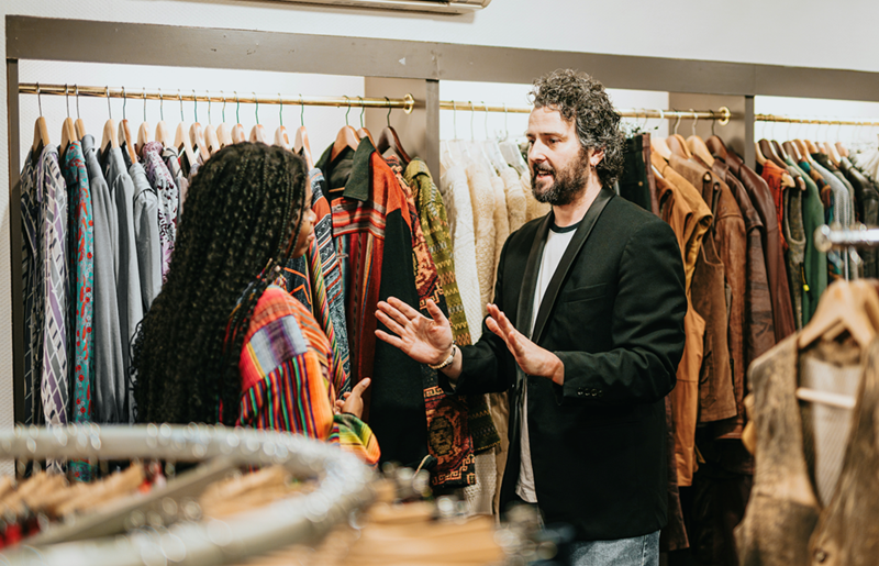 A manager and a retail worker have a tense conversation in the clothing department.