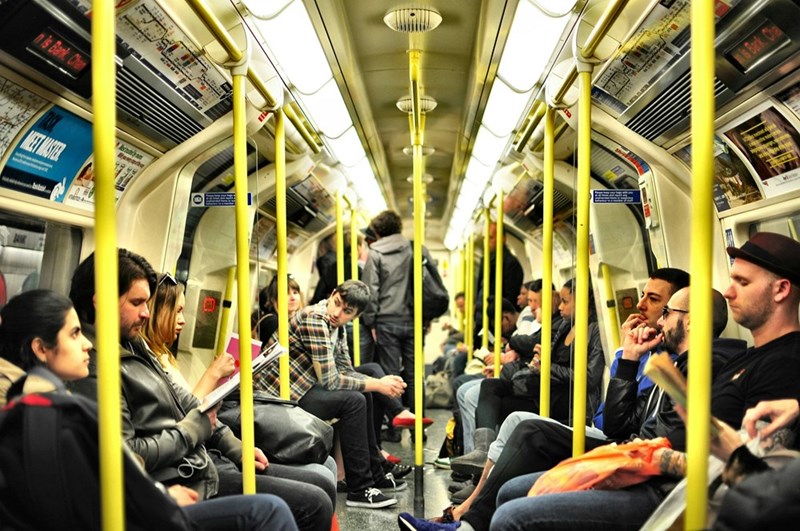 Photo of group of people sitting inside of train