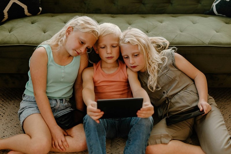 A group of kids watches a show on an iPad right before the WiFi gets cut.