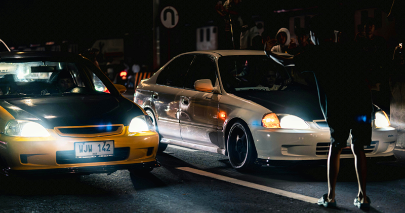 Night Street Car Racing with Bystanders