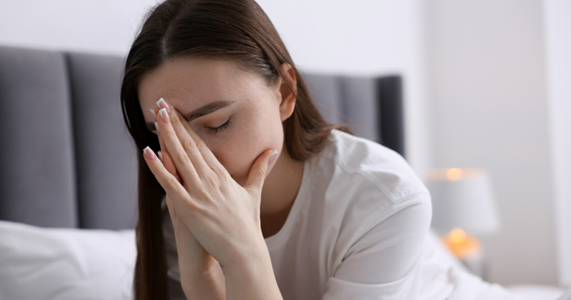 Woman feeling stressed out with her head in her hands. 