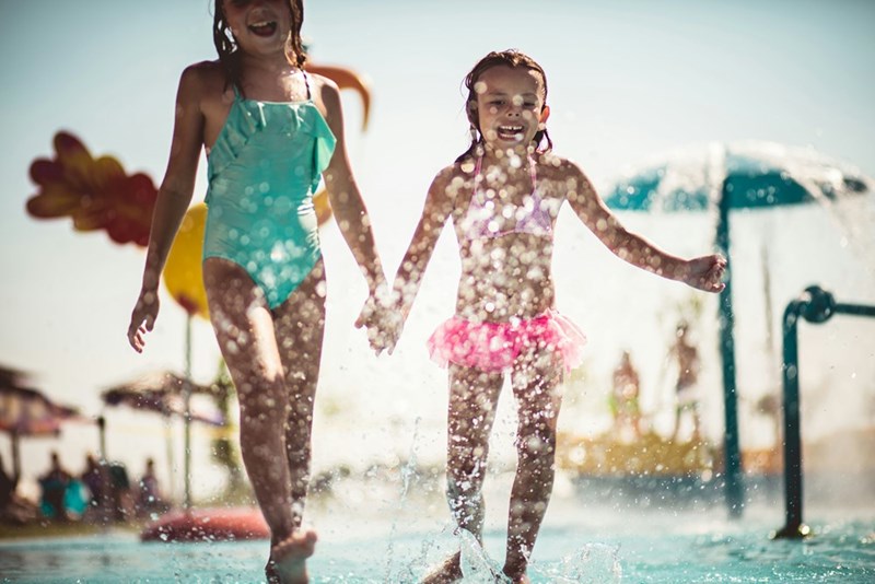 Two of the neighbor's kids running into the pool.