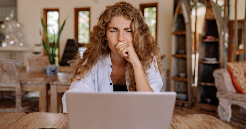 Woman Looking Serious While Using Laptop