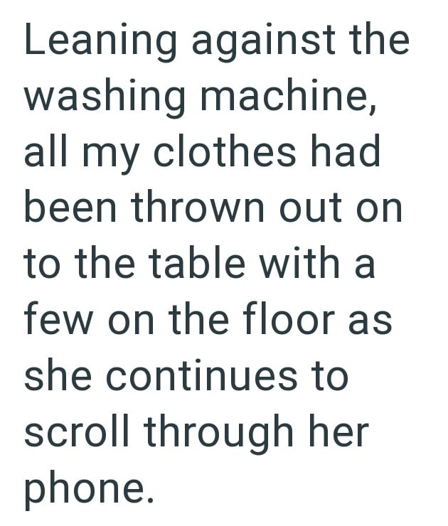 Leaning against the washing machine, all my clothes had been thrown out on to the table with a few on the floor as she continues to scroll through her phone.