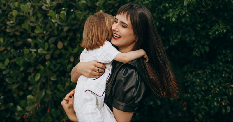 Aunt happily embracing her nephew after not seeing him for a long time. 