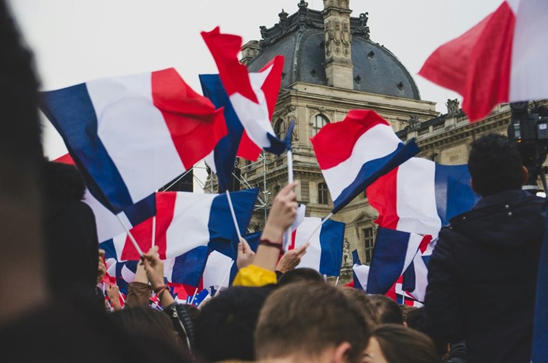 People holding French Flag in the street