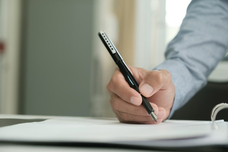 Close-up of businessman signing a contract