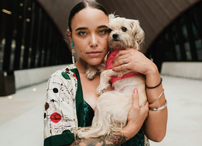 Woman looking disappointed while holding a dog.