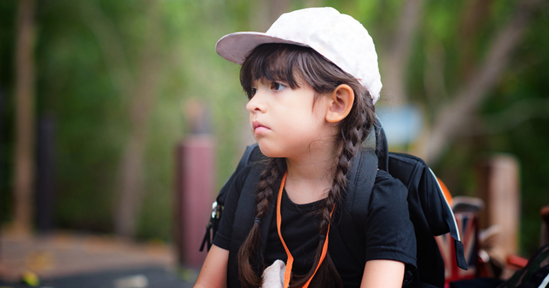 Sad-looking young girl at a school field trip.