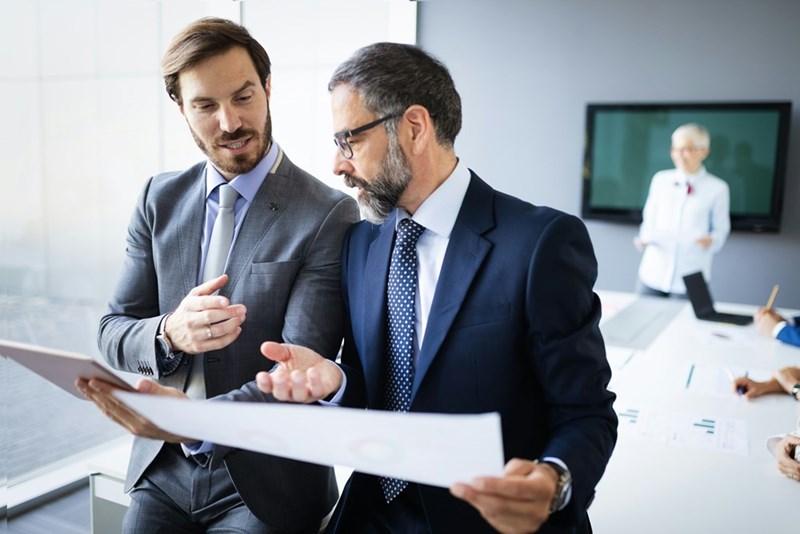 collaboration and analysis by business people working in modern office