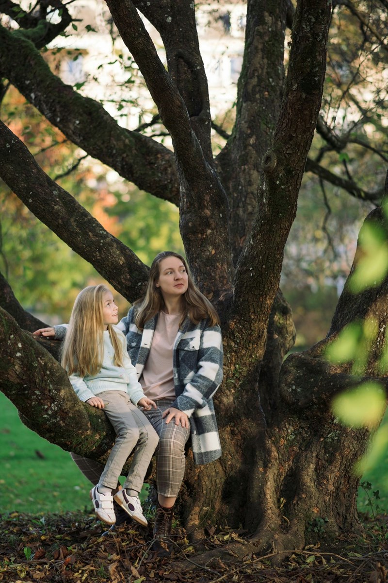 Mom and daughter sit in special family tree together.