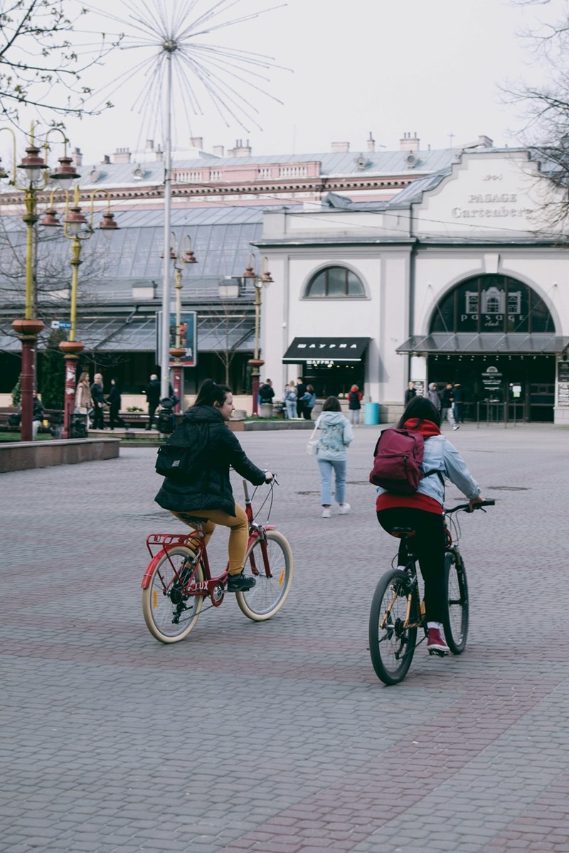 People riding bikes on a brick road