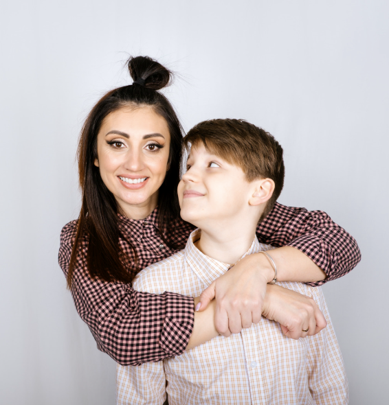 Shy younger brother looking up to his adult older sister.