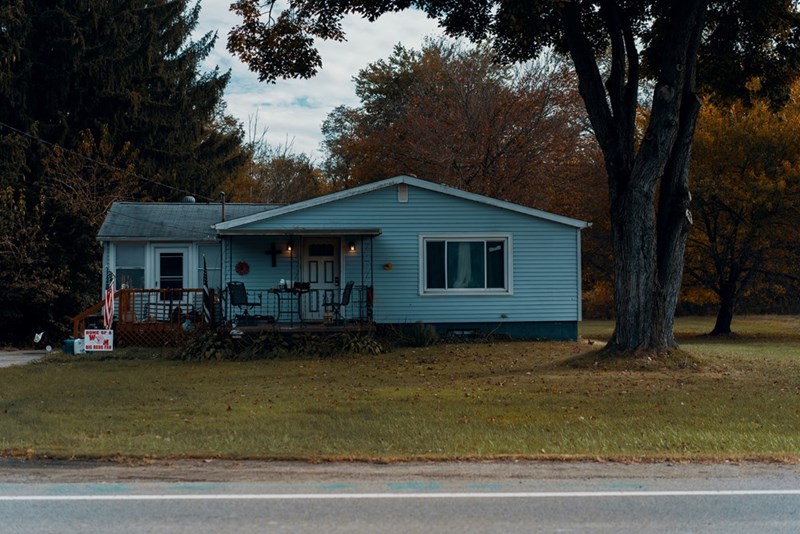 Blue house beside tree