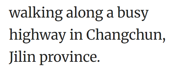 walking along a busy highway in Changchun, Jilin province.