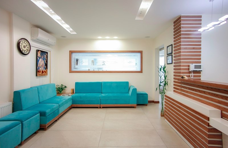 Waiting room with teal seating.